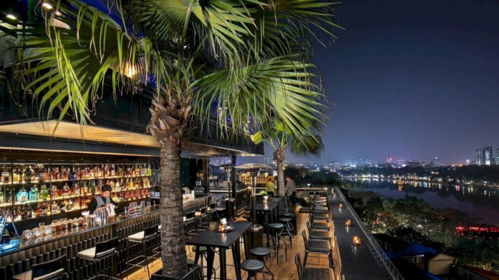 Vietnam Nightlife Guide 2026: Best Bars, Rooftops, Clubs & Night Markets 🇻🇳 6 Locals and travelers drinking bia hoi on Ta Hien Beer Street in Hanoi Vietnam