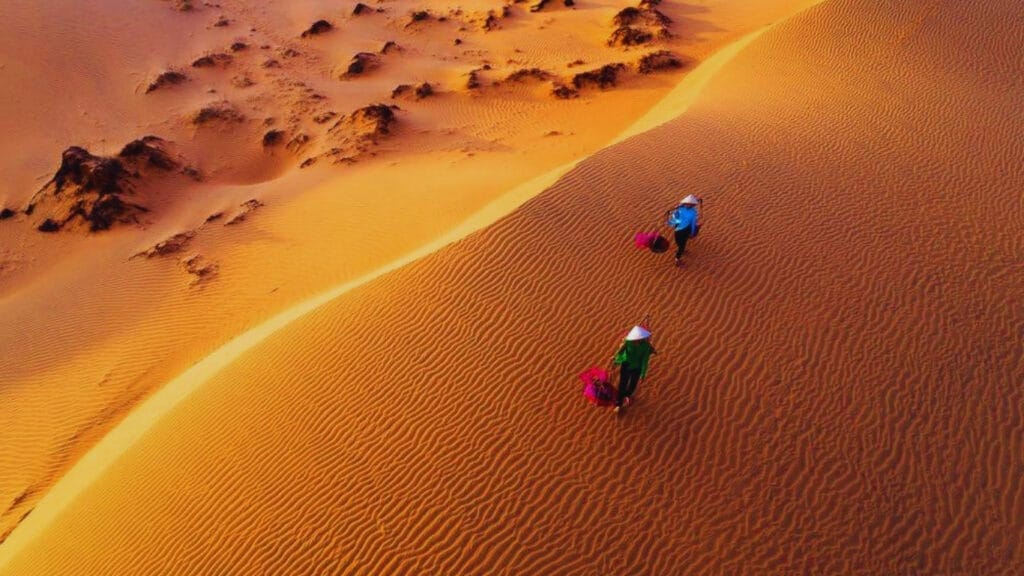 Mui Ne Travel Guide 2026: Vietnam’s Best Beach Escape for Sand Dunes, Seafood & Kitesurfing 13 Travelers enjoying sunset on the beach in Mui Ne Vietnam