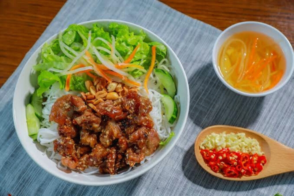 Vietnamese vegetarian grilled tofu vermicelli bowl with herbs
