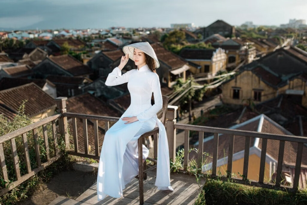 Ao Dai Vietnam: History, Meaning & Where to Wear Vietnam's National Dress 7 A traveler wears the Ao Dai at Hoi An