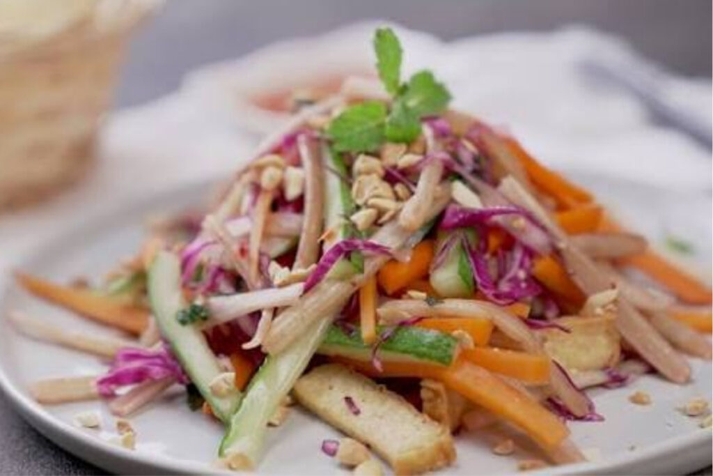 Vietnamese lotus stem vegetarian salad with herbs and peanuts