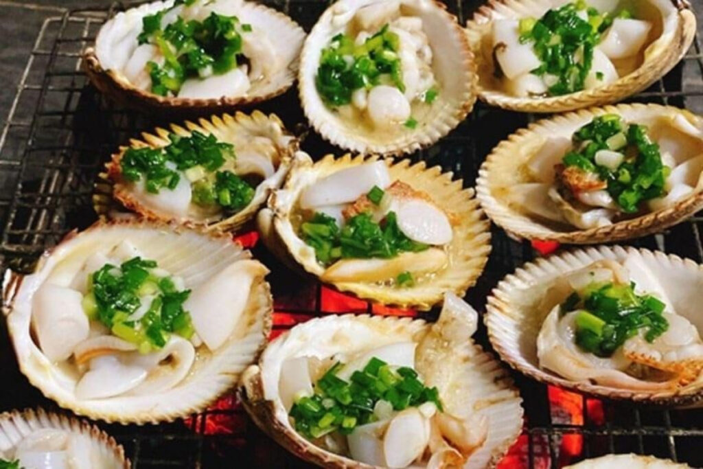 Seafood in Vietnam: 18 Must-Try Dishes & Where to Eat Them (2026 Traveler's Guide) 7 Vietnamese grilled scallops topped with scallion oil