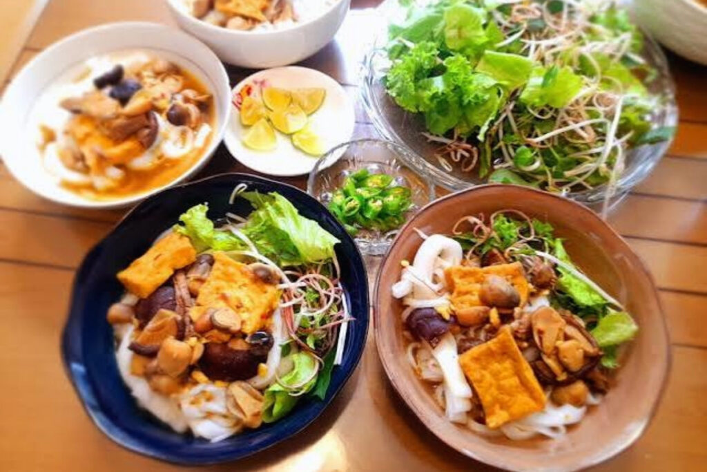 Vegetarian mi Quang noodles with peanuts herbs tofu and rice crackers