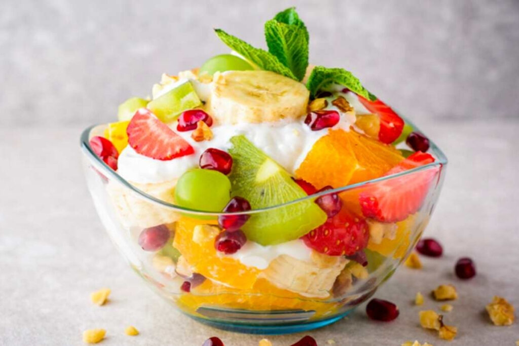 Best Vietnamese Desserts: 20 Sweet Treats Every Traveler Should Try in Vietnam 18 Vietnamese mixed tropical fruit dessert with mango, dragon fruit, papaya, jackfruit, avocado, coconut milk, and crushed ice.
