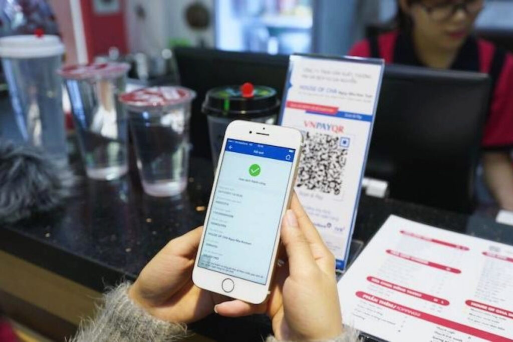 Vietnamese Etiquette Guide: 25 Cultural Tips Every Traveler Should Know Before Visiting Vietnam 13 Customer paying with a QR code at a Vietnamese café