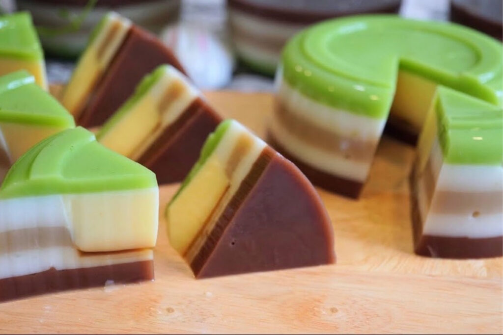 Best Vietnamese Desserts: 20 Sweet Treats Every Traveler Should Try in Vietnam 19 Colorful Vietnamese rau câu jelly dessert made with coconut milk, pandan, coffee, mango, and layered fruit flavors.