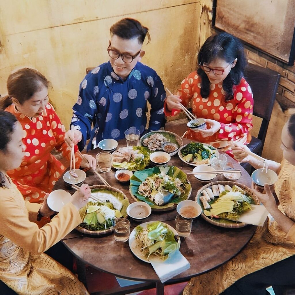 Vietnamese host serving food to a guest