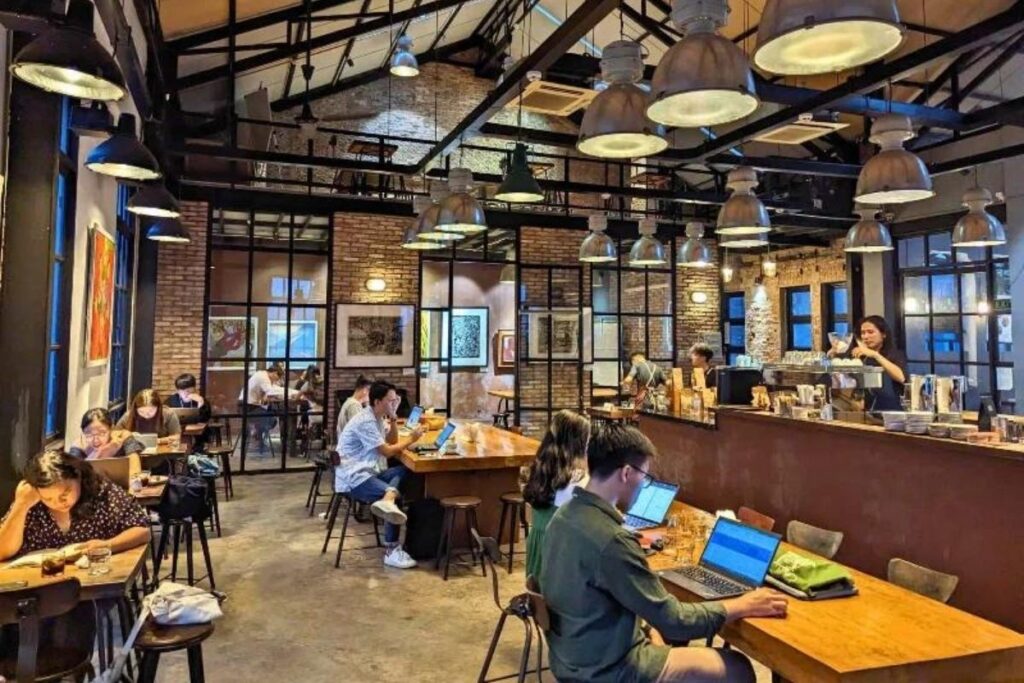 Vietnamese Customs and Traditions: Why Vietnam Feels So Different—and So Welcoming 8 Young professionals working from a café in Ho Chi Minh City