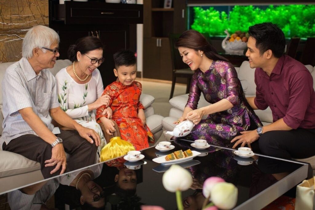 Vietnamese Customs and Traditions: Why Vietnam Feels So Different—and So Welcoming 5 Younger family members serving tea to grandparents