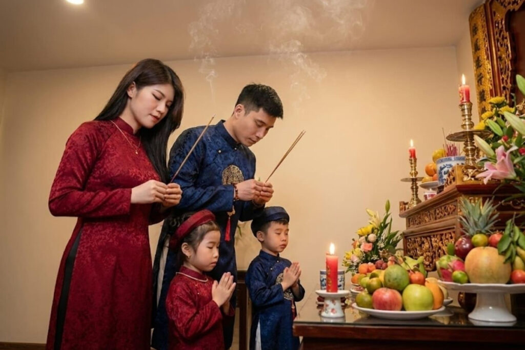 Tet Holiday in Vietnam: Traditions, Food, Customs, and How Vietnamese Celebrate Lunar New Year 9 Traditional Vietnamese family altar prepared for Tet with flowers and offerings