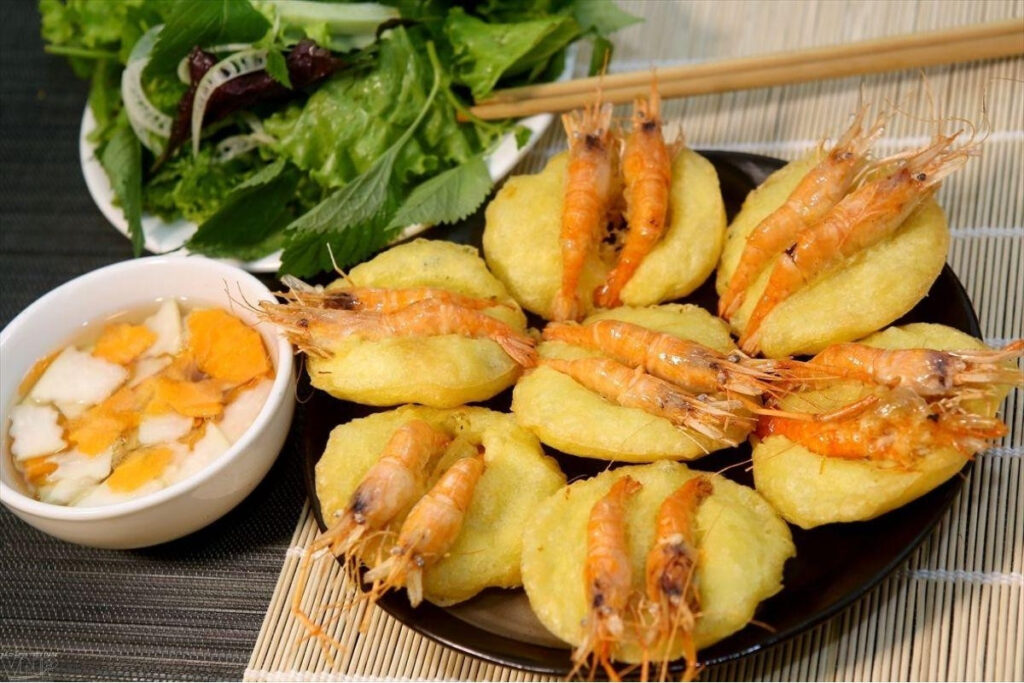 Hanoi Food Guide: 15 Must-Try Dishes & Where to Eat Like a Local 10 Crispy Hanoi banh tom shrimp cakes served with herbs and dipping sauce near West Lake.