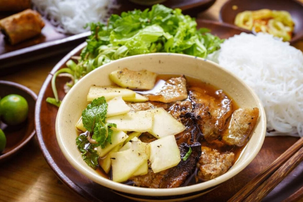 Hanoi Food Guide: 15 Must-Try Dishes & Where to Eat Like a Local 3 Hanoi bun cha with charcoal-grilled pork, rice noodles, fresh herbs, and dipping sauce served for lunch.