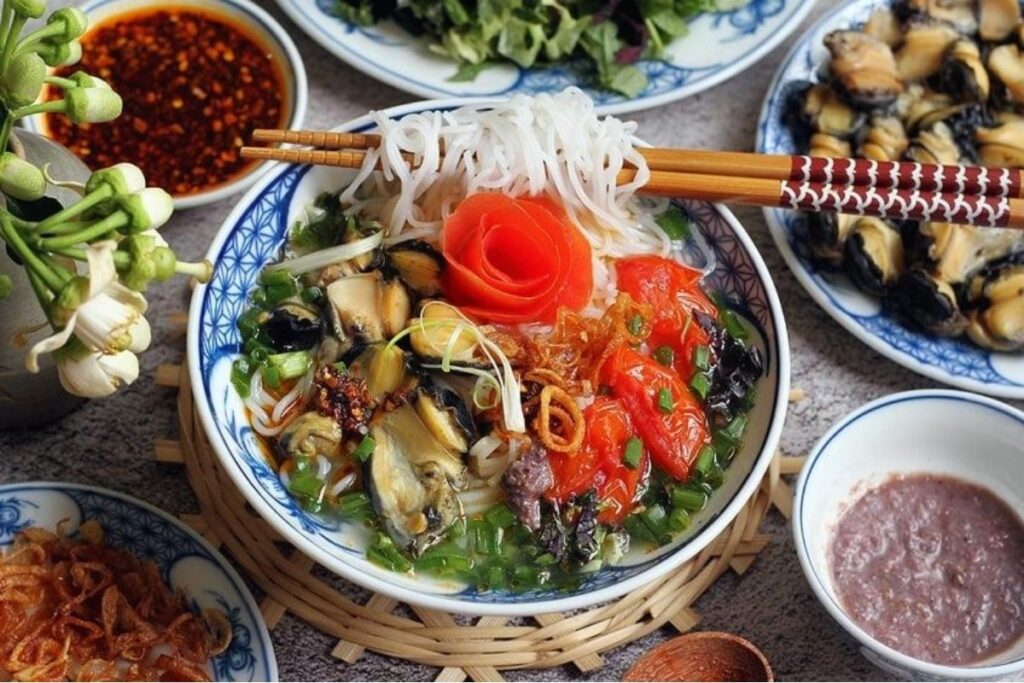 Hanoi Food Guide: 15 Must-Try Dishes & Where to Eat Like a Local 11 Hanoi bun oc with freshwater snails, tomatoes, herbs, tofu, and vermicelli noodles.