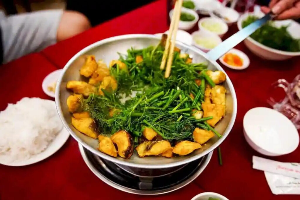 Hanoi Food Guide: 15 Must-Try Dishes & Where to Eat Like a Local 4 Cha Ca Hanoi with turmeric-marinated fish, fresh dill, spring onions, rice noodles, and peanuts.