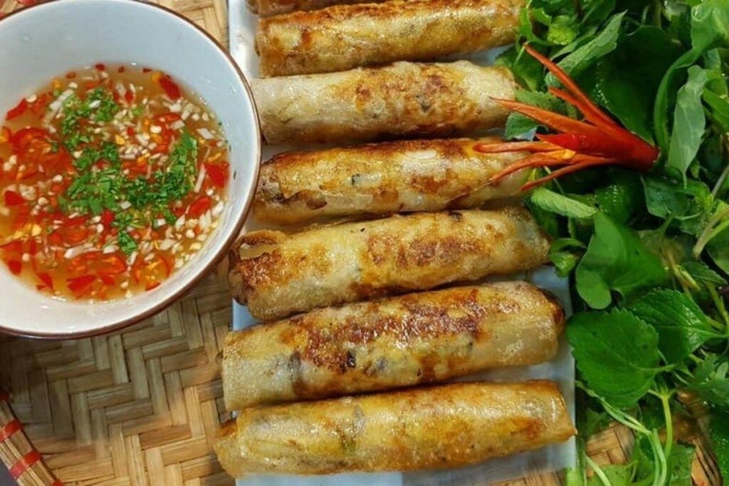 Hanoi Food Guide: 15 Must-Try Dishes & Where to Eat Like a Local 9 Crispy Hanoi nem ran served with lettuce, fresh herbs, and fish sauce.