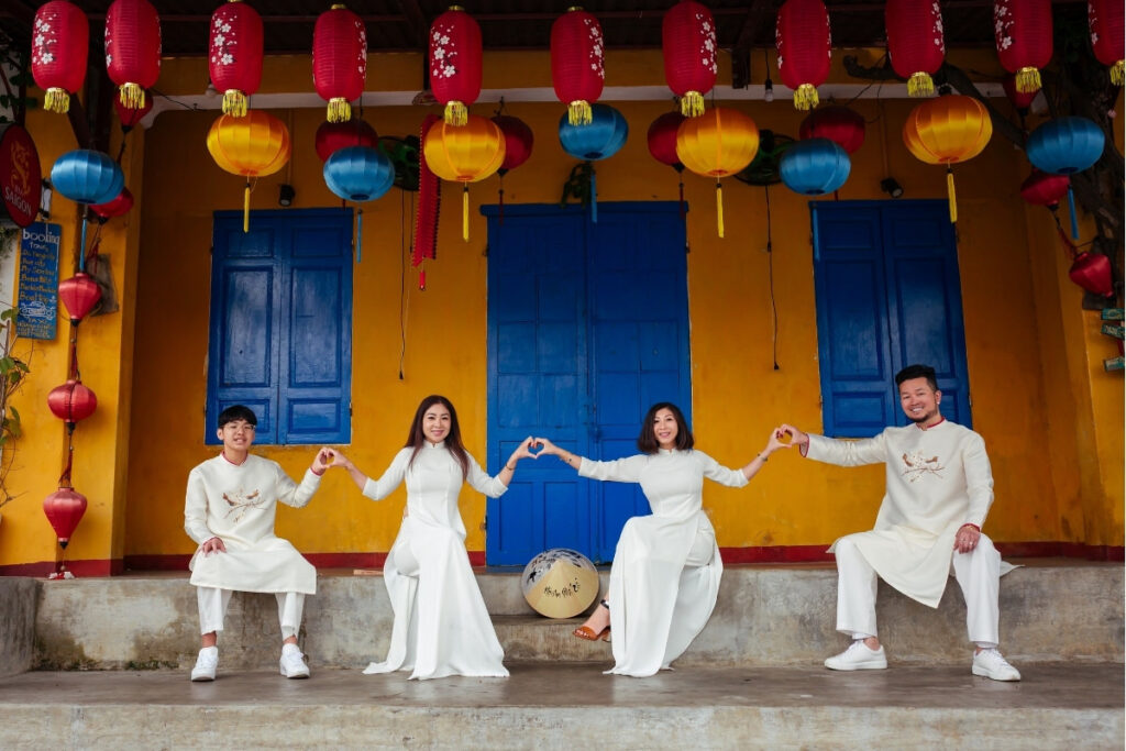 Ao Dai Vietnam: History, Meaning & Where to Wear Vietnam's National Dress 3 Vietnamese family wearing Ao Dai during Tet Holiday