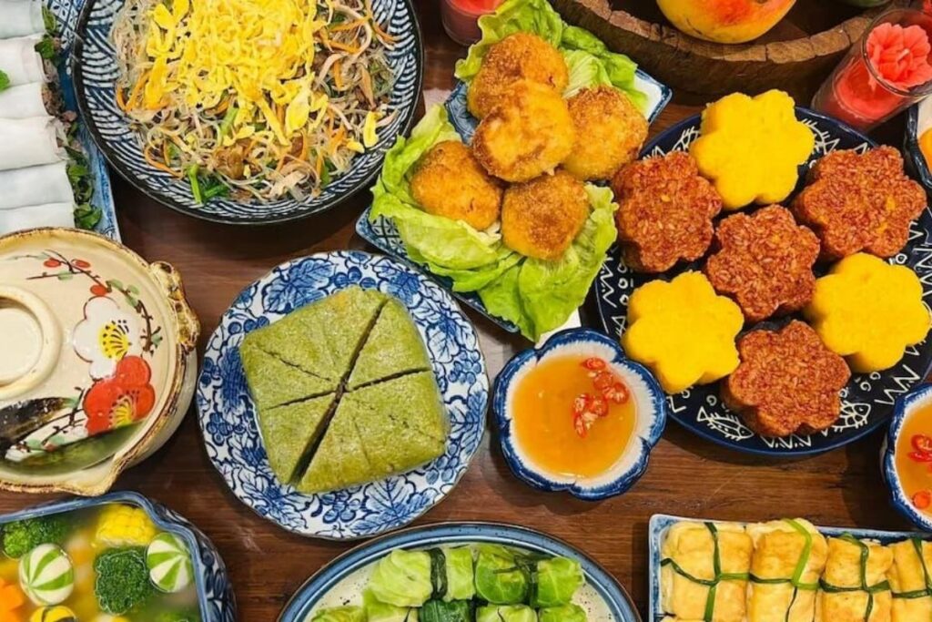 Traditional Vietnamese festival foods including banh chung, mooncakes, sticky rice, and fruit offerings
