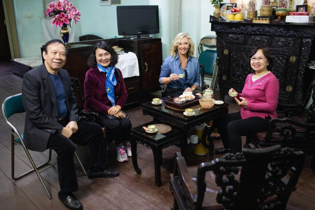 Vietnamese Etiquette Guide: 25 Cultural Tips Every Traveler Should Know Before Visiting Vietnam 15 Traveler sharing tea with a Vietnamese family