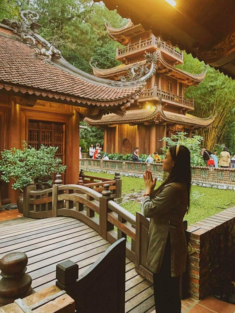 Vietnamese Etiquette Guide: 25 Cultural Tips Every Traveler Should Know Before Visiting Vietnam 8 Traveler visiting a Vietnamese pagoda respectfully