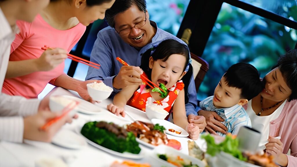 Vietnamese Family Culture: Three generations of a Vietnamese family sharing dinner together