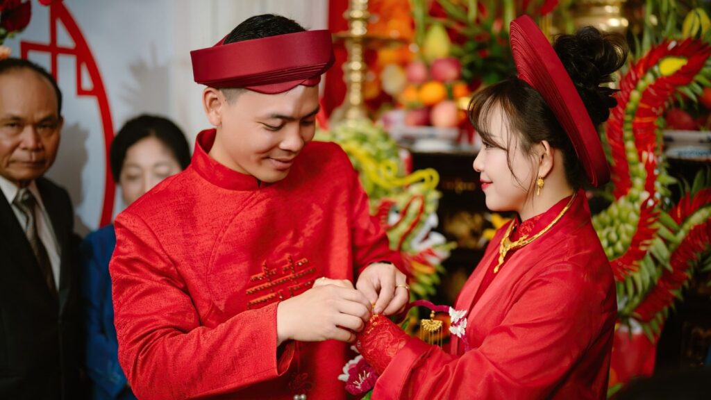 Vietnamese wedding Traditions with bride and groom wearing Ao Dai and ceremonial gift trays