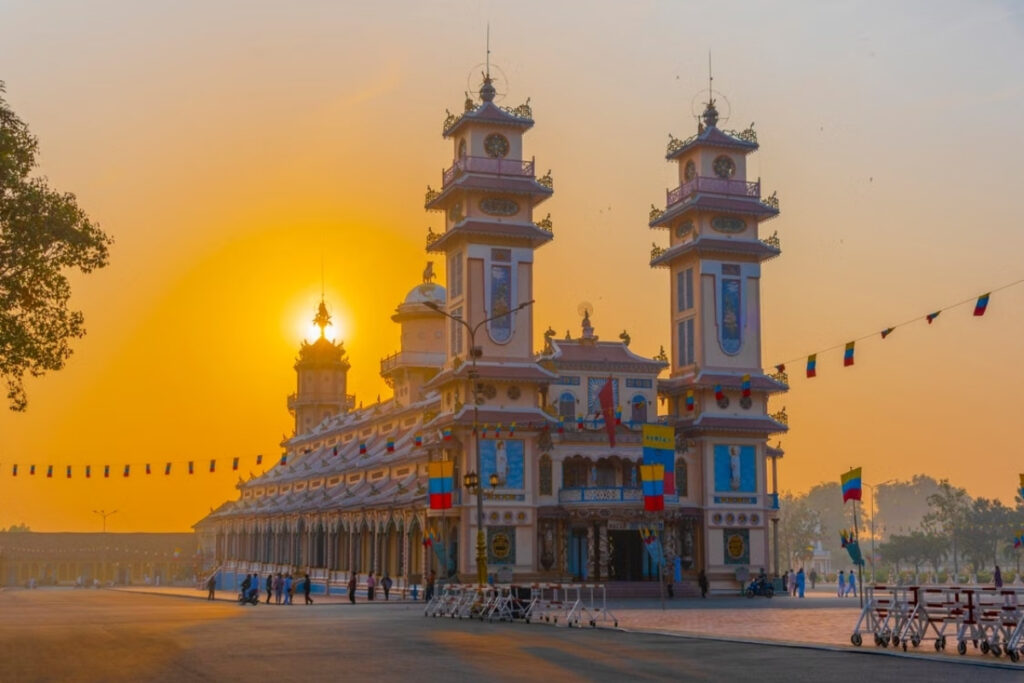 Vietnamese Religion & Beliefs: A Complete Guide to Faith, Spirituality, and Daily Life in Vietnam (2026) 10 Stunning sunset view of the Cao Dai Temple in Tay Ninh, Vietnam, showcasing its unique architecture.