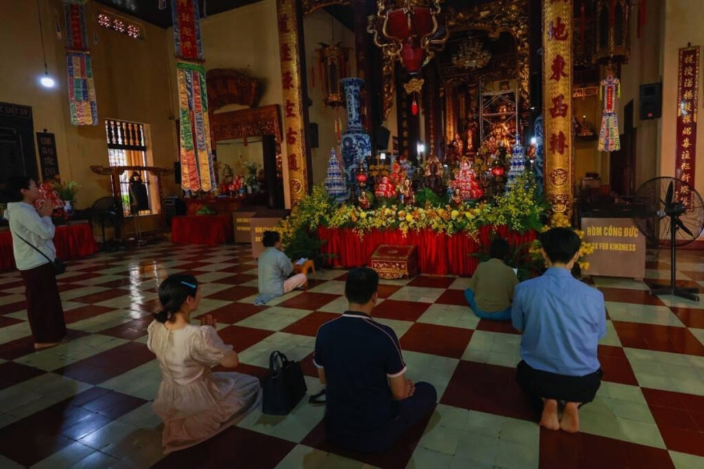Vietnamese Religion & Beliefs: A Complete Guide to Faith, Spirituality, and Daily Life in Vietnam (2026) 12 Respectful visitors inside a Buddhist temple