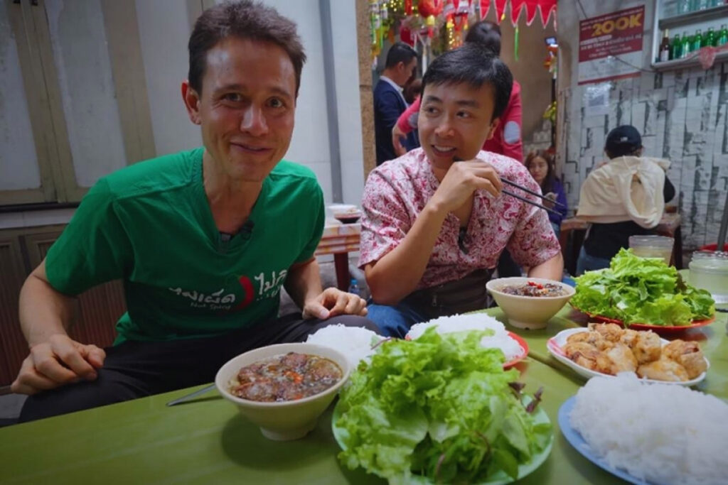 Foreigner eating Vietnamese food at a local restaurant in Vietnam