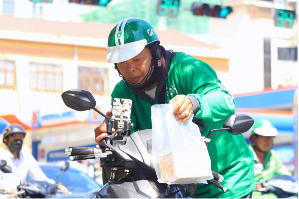 Food delivery rider on a motorbike in Vietnam
