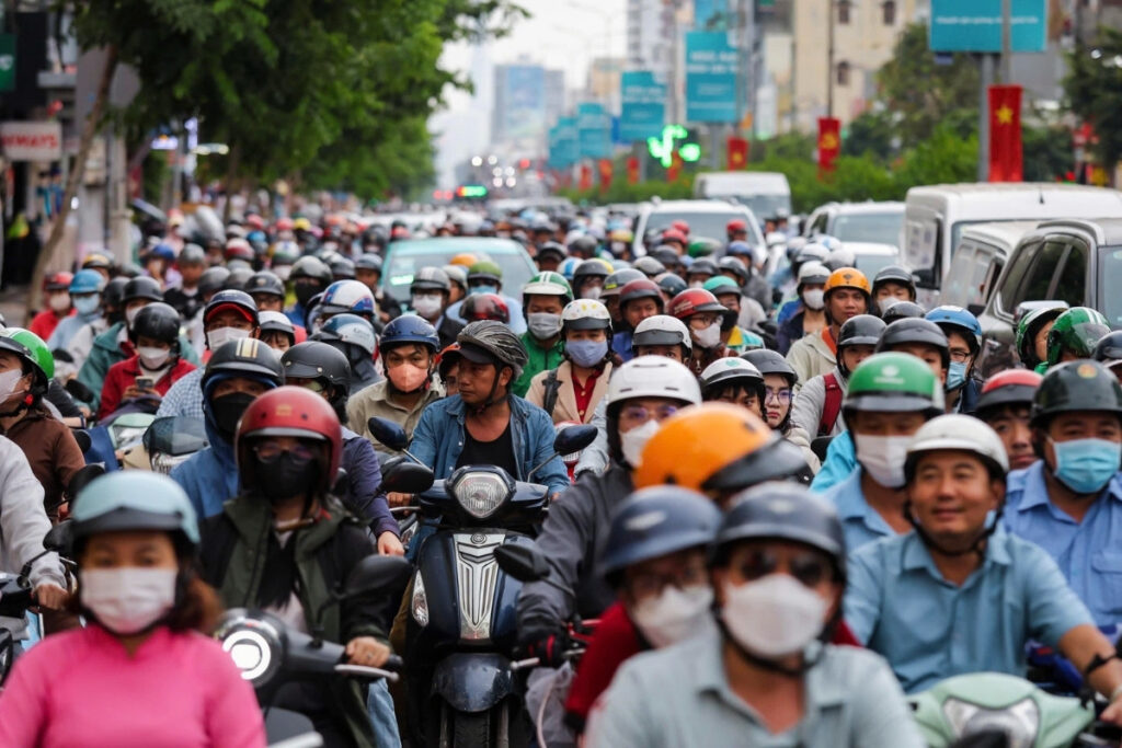 Motorbikes moving through heavy traffic in Ho Chi Minh City