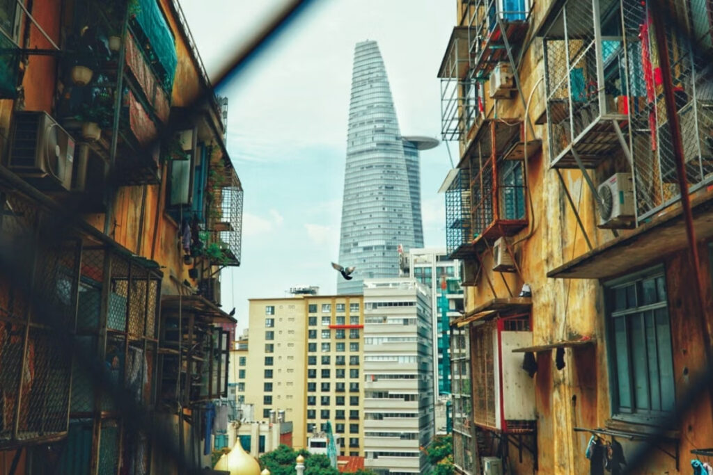 Traditional neighborhood and modern buildings sharing the same street in Vietnam