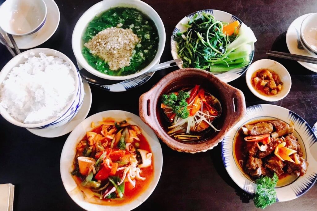 Why Do Vietnamese Families Eat Together? 6 Traditional Vietnamese family meal with rice soup and vegetables