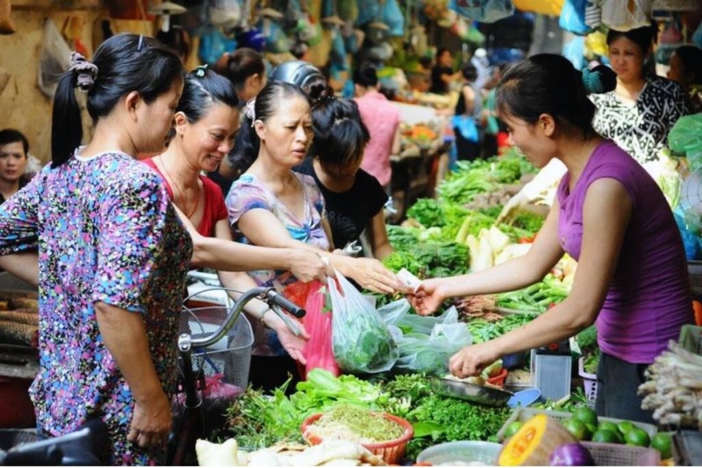 Crowded Vietnamese market with local shoppers in Hanoi