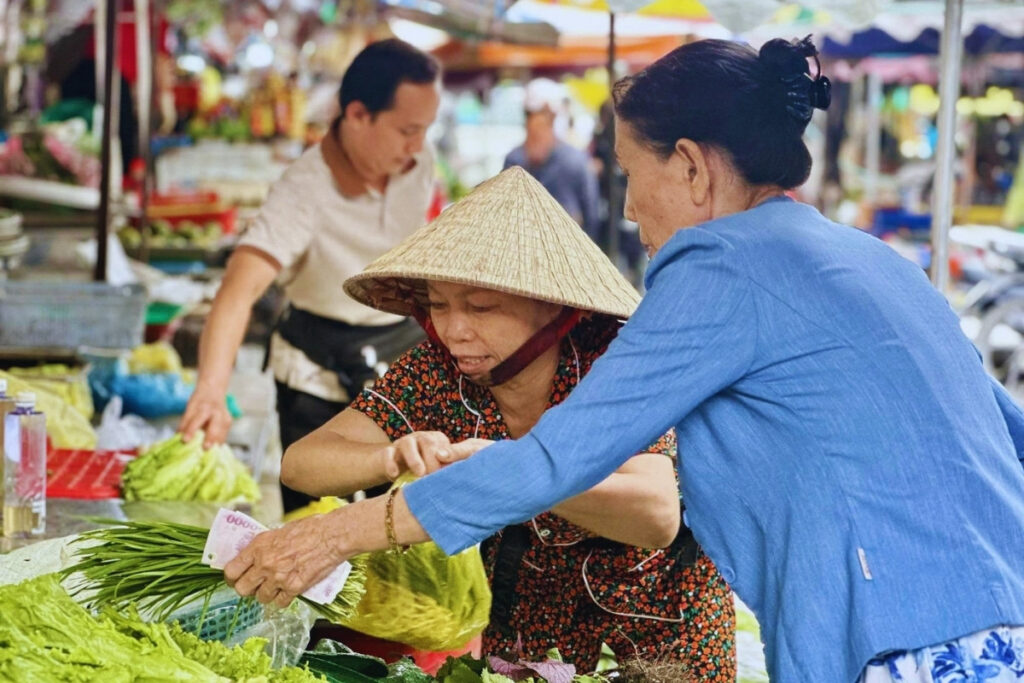 Customer shopping at a traditional market in Vietnam