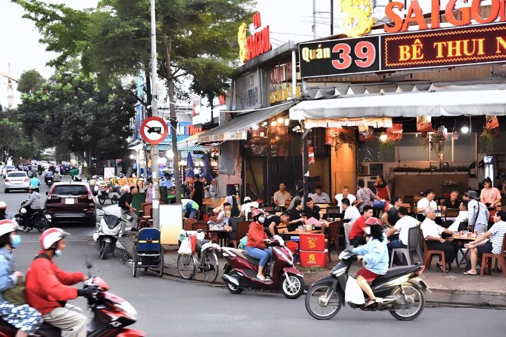 Vietnamese sidewalk used for parking, dining, and everyday activities