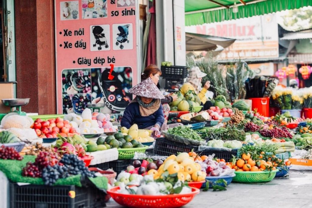 Local vendors selling fresh produce at a Vietnamese morning market