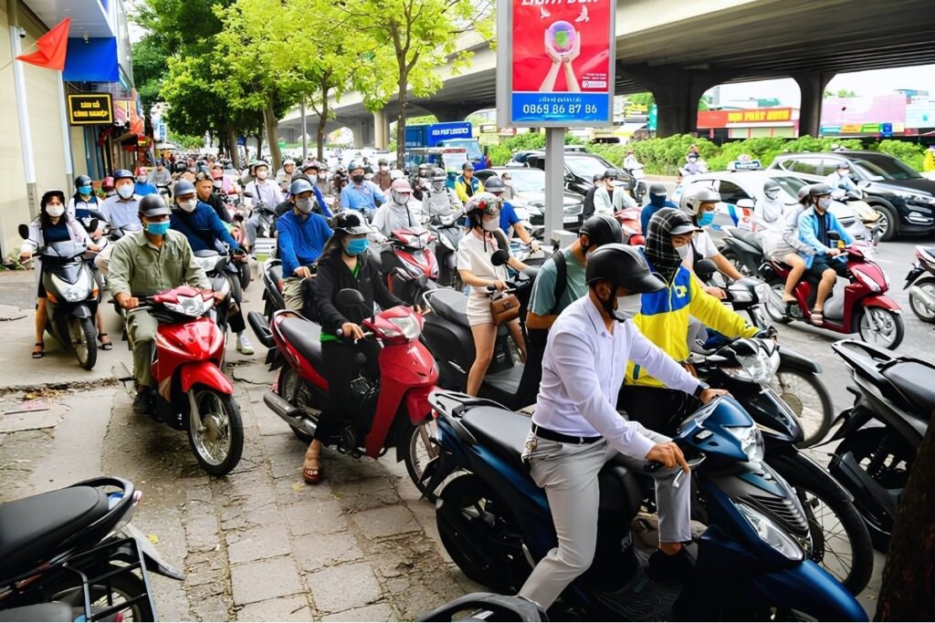 Vietnamese commuters traveling by motorbike in Hanoi
