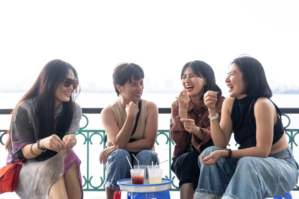 Vietnamese colleagues talking over coffee before work