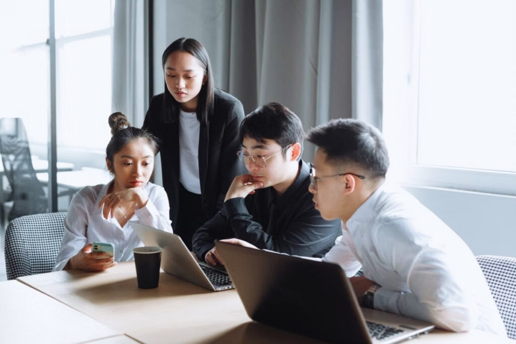 Vietnamese colleagues discussing a work project after a meeting