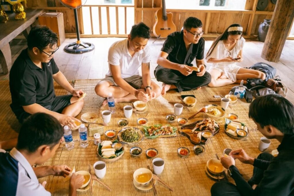 Vietnamese family sharing several dishes around a dining table
