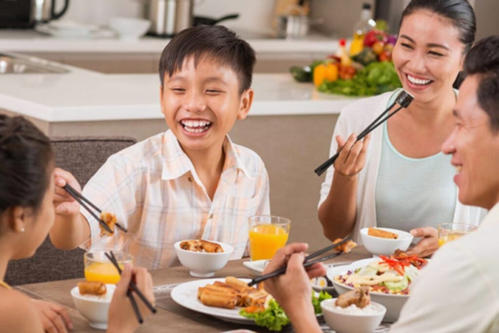 Why Do Vietnamese Families Eat Together? 5 Vietnamese family member serving food to another person