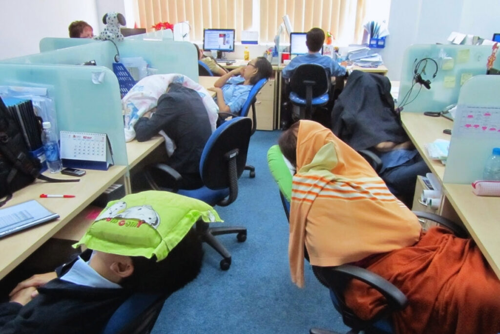 Vietnamese office workers resting during a lunch break