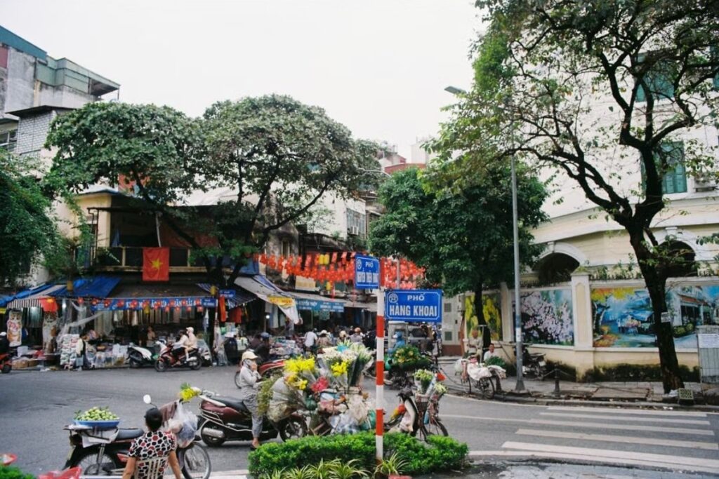 Everyday street life with pedestrians, vendors, and motorcycles in Vietnam