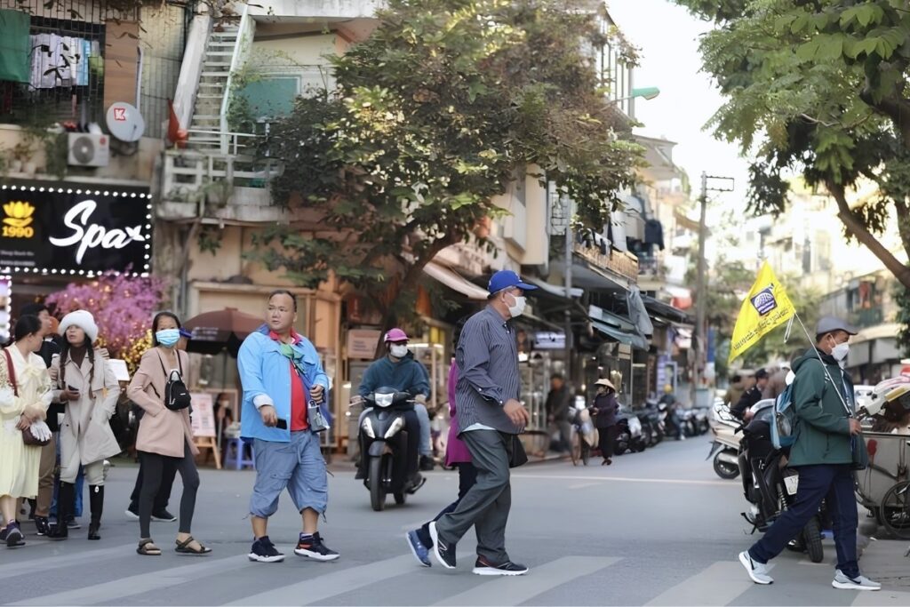 Traveler standing at the curb before crossing a busy street in Vietnam