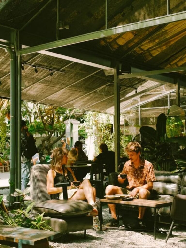 Foreign visitor enjoying coffee at a neighborhood café in Vietnam
