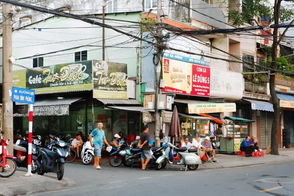 Pedestrians, parked motorcycles, and street businesses sharing a sidewalk in Vietnam